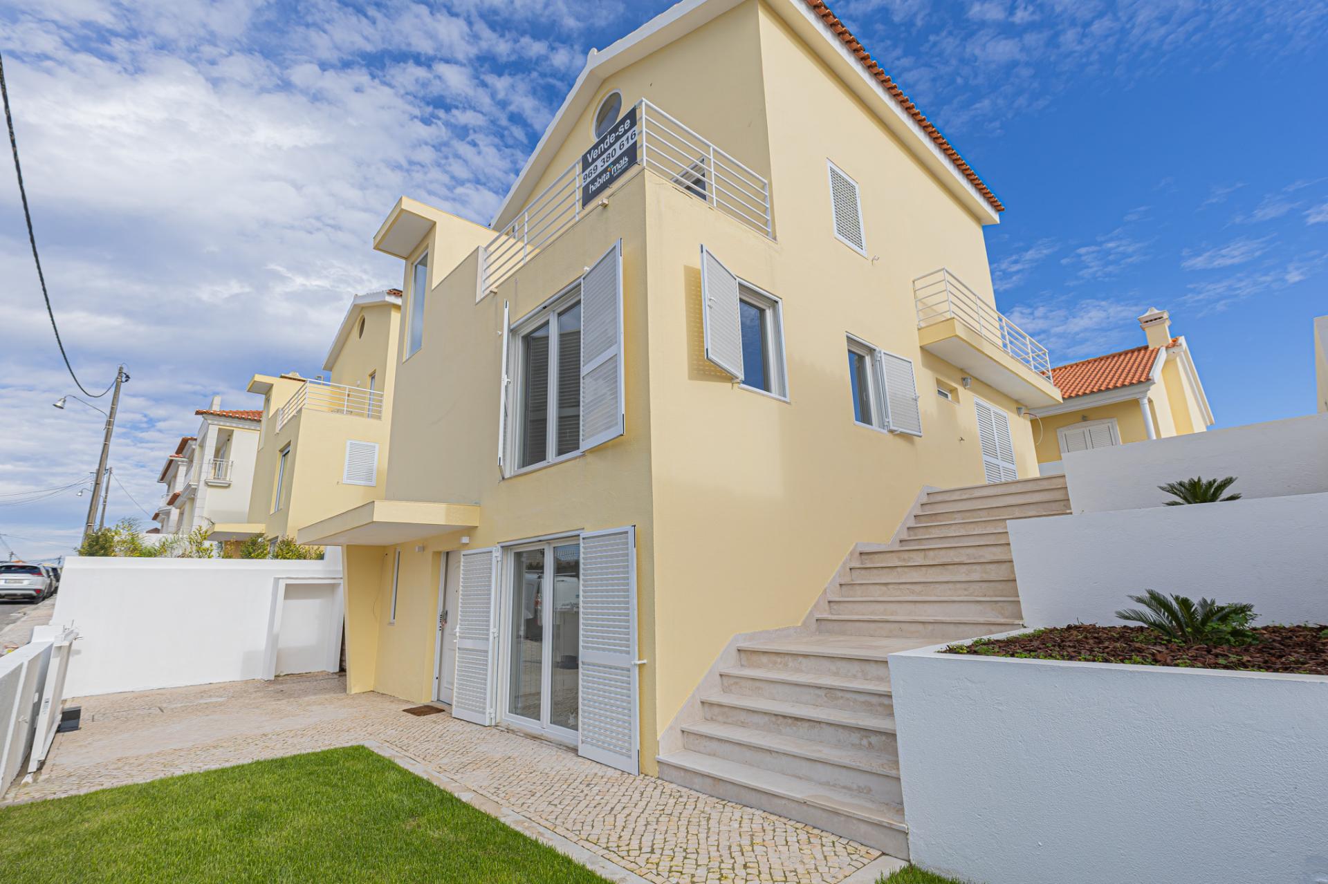 Moradia T5 isolada (A+) com 4 WC, varandas amplas, jardim relvado, garagem e vista desafogada.