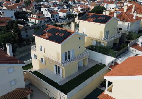 Moradia T5 isolada (A+) com 4 WC, varandas amplas, jardim relvado, garagem e vista desafogada.